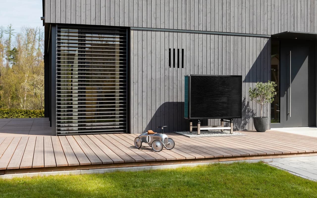 Daikin Altherma 3 H MT buitenunit bij een houten gevel; fabrikantvoorbeeld